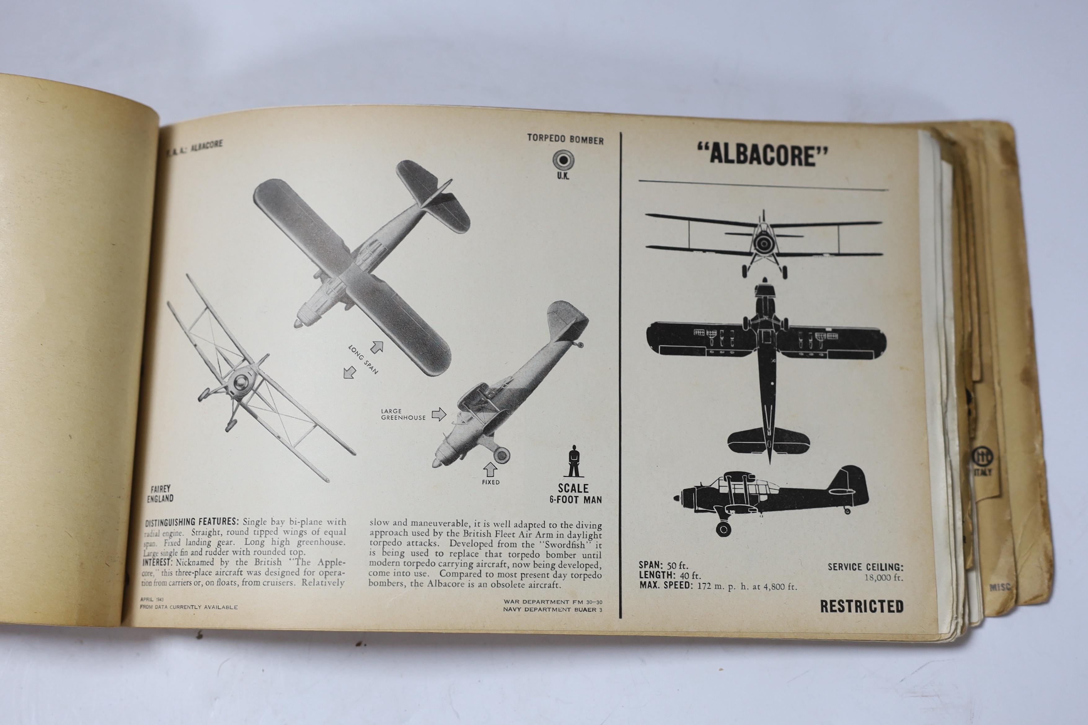 A WWII Air Ministry altimeter model XIV B and a War & Navy Department aircraft recognition pictorial manual